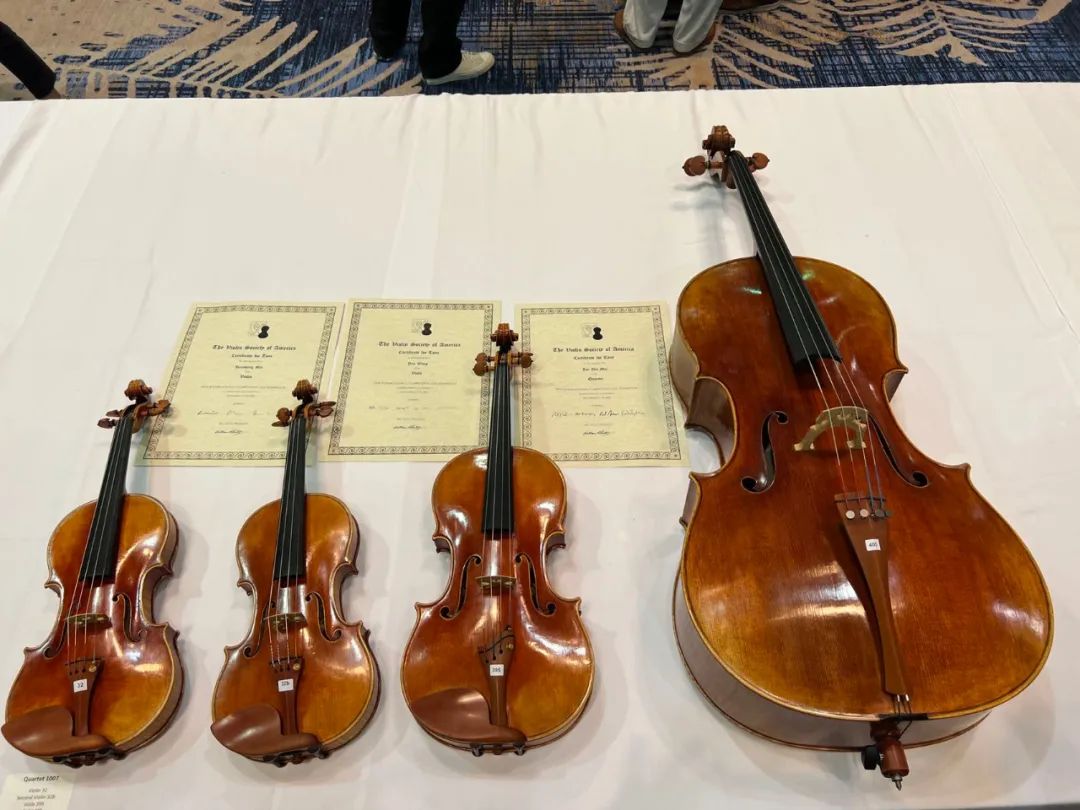 Three violas and violins and a cello with their VSA tone award certificates from the 2022 competition
